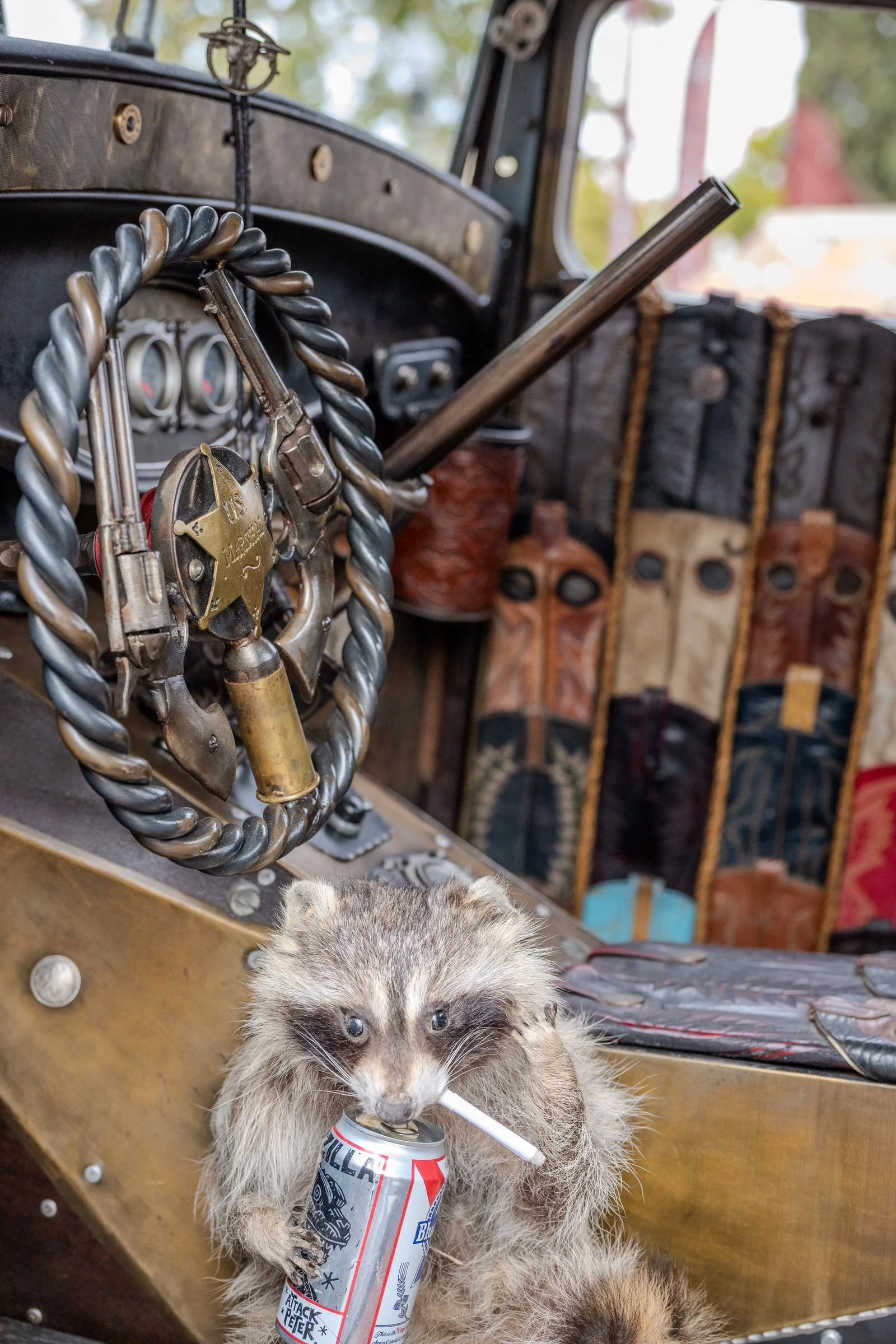 Rat rod cabin with a sculpted steering wheel and decorative ornaments.