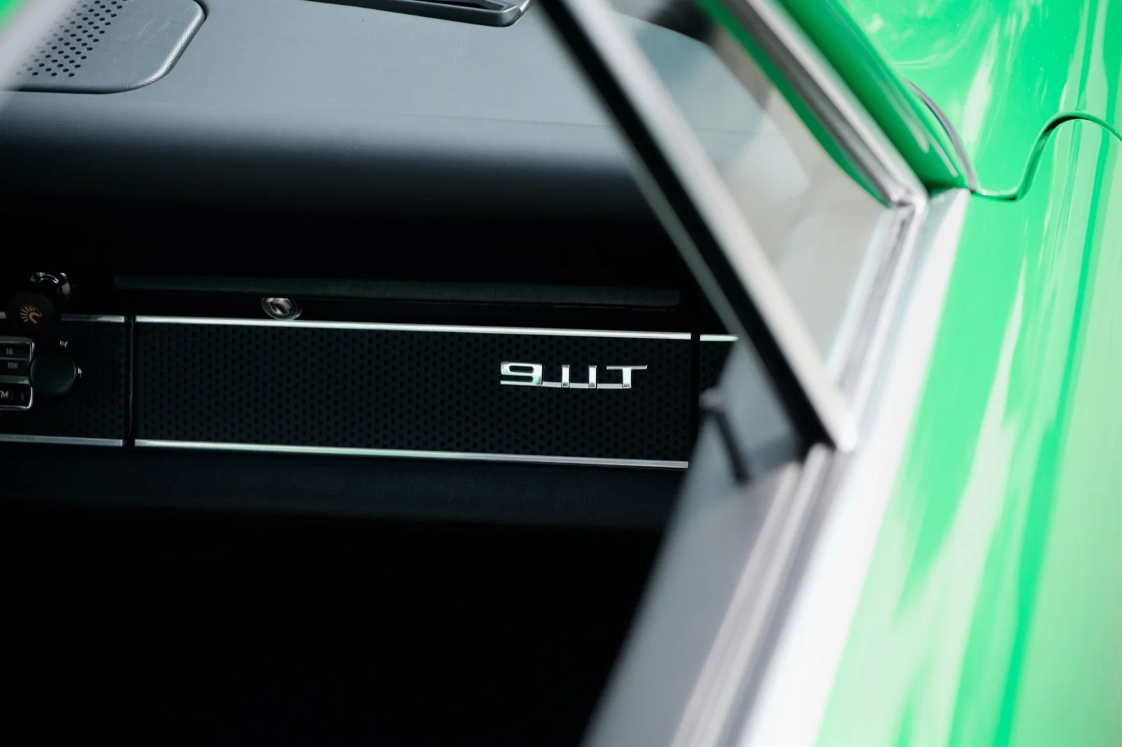911T dashboard badge through the green window frame.